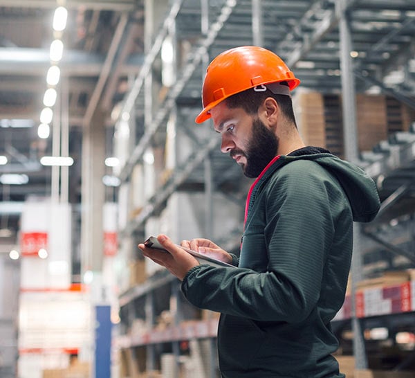 Worker in warehouse looking at tablet