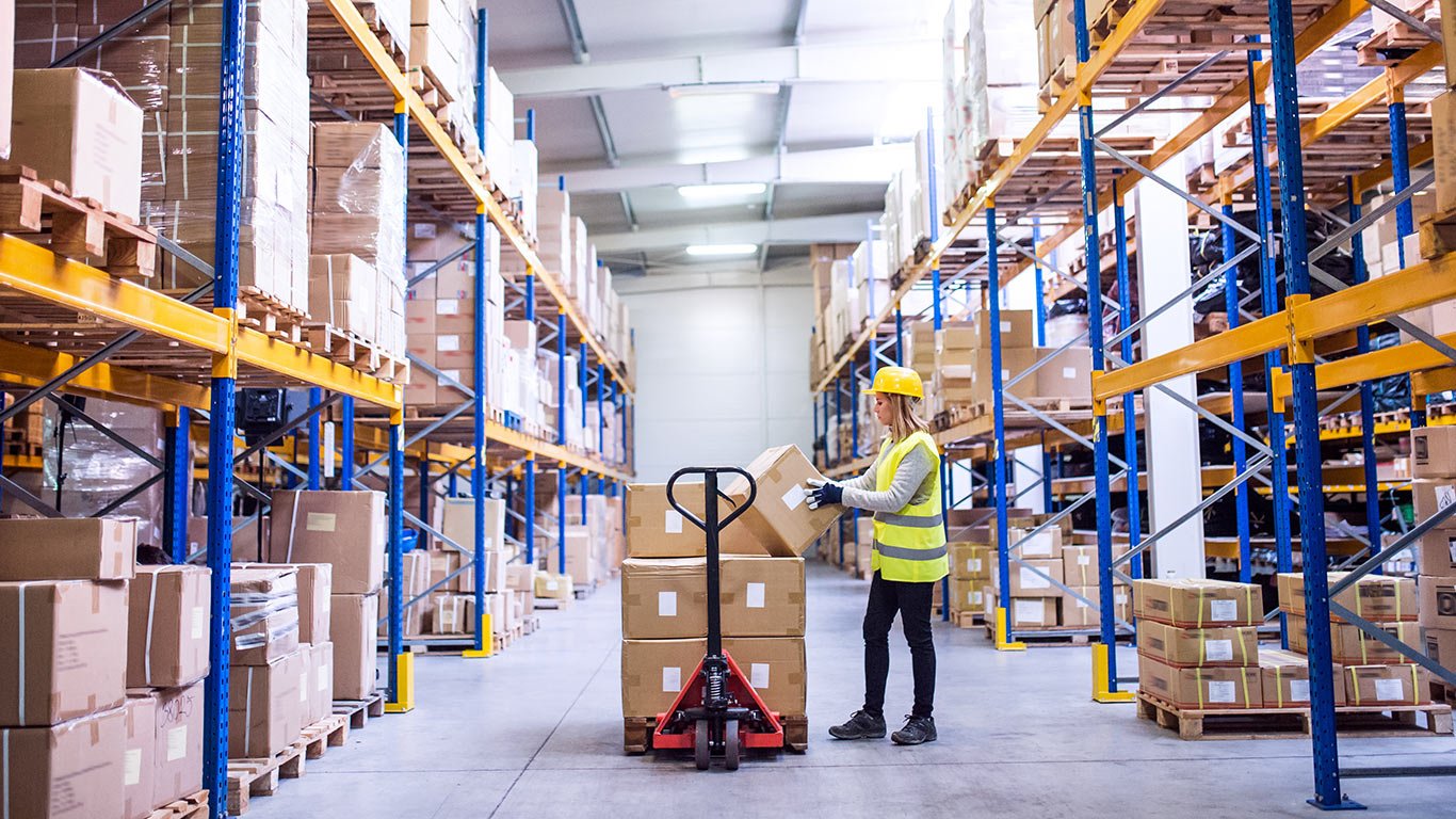 Female warehouse worker loading boxes